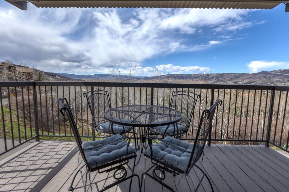 2626 Longthong Road, Unit 203 Steamboat Springs, CO 80487 - Photo 14 of 42 Wooden deck with a mountain view and outdoor dining area
