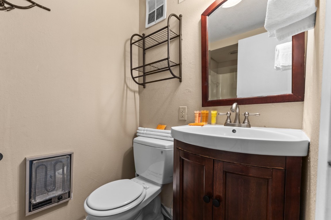 2626 Longthong Road, Unit 203 Steamboat Springs, CO 80487 - Photo 17 of 42 Bathroom with visible vents, toilet, heating unit, and vanity