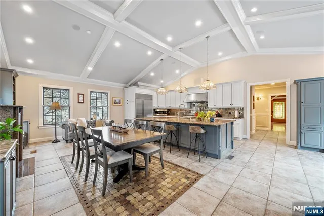 a living room with lots of furniture and kitchen view