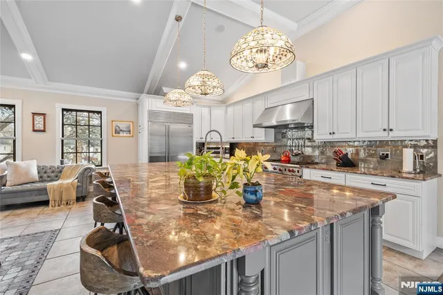 a view of a kitchen with dining table and stainless steel appliances