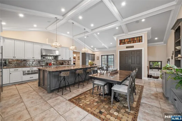 a kitchen with a table chairs stove and kitchen view