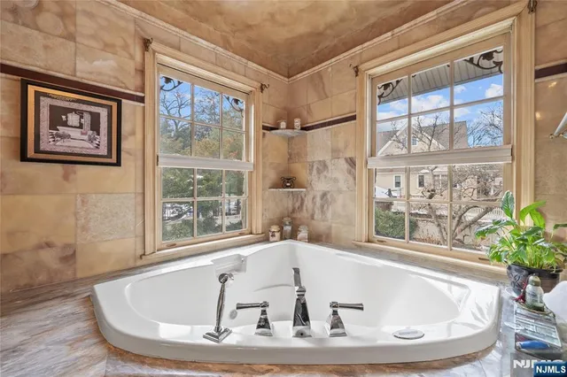 a bath tub sitting in a bathroom next to a window