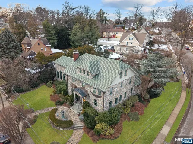 an aerial view of a house with yard swimming pool and outdoor seating