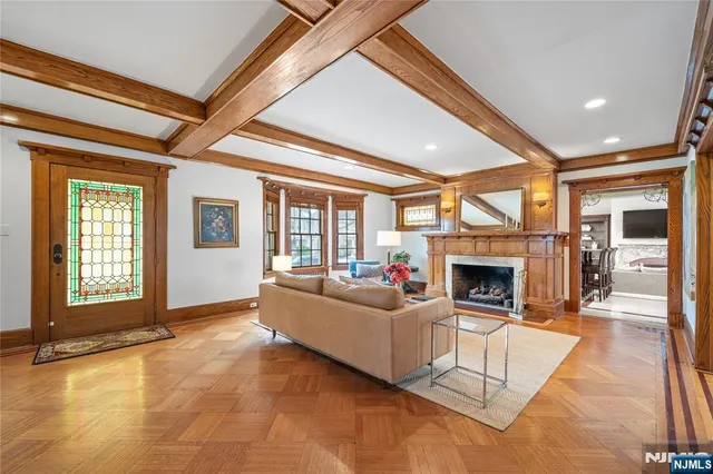 a living room with furniture a fireplace and a table