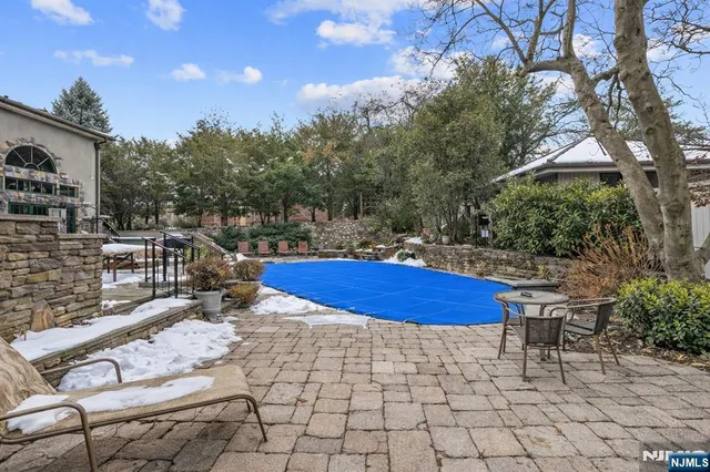 a swimming pool with outdoor seating and yard