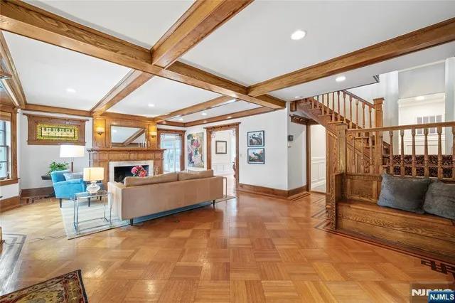 a living room with furniture a fireplace and a large window