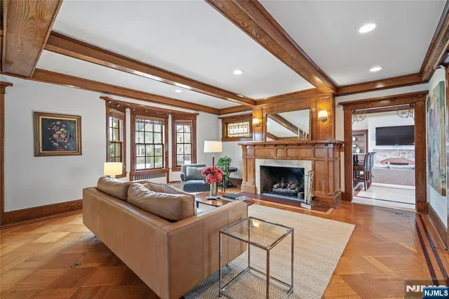 a living room with furniture a fireplace and a large window