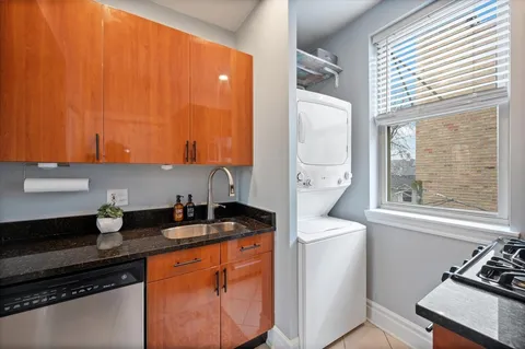 a kitchen with a sink a stove and cabinets