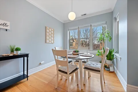 a view of a dining room with furniture and a potted plant
