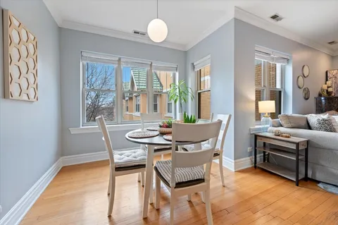 a view of a dining room with furniture wooden floor and a rug