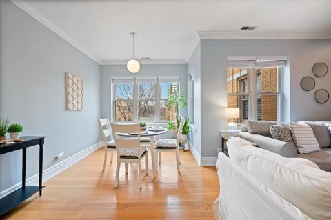 a living room with furniture dining table and a large window