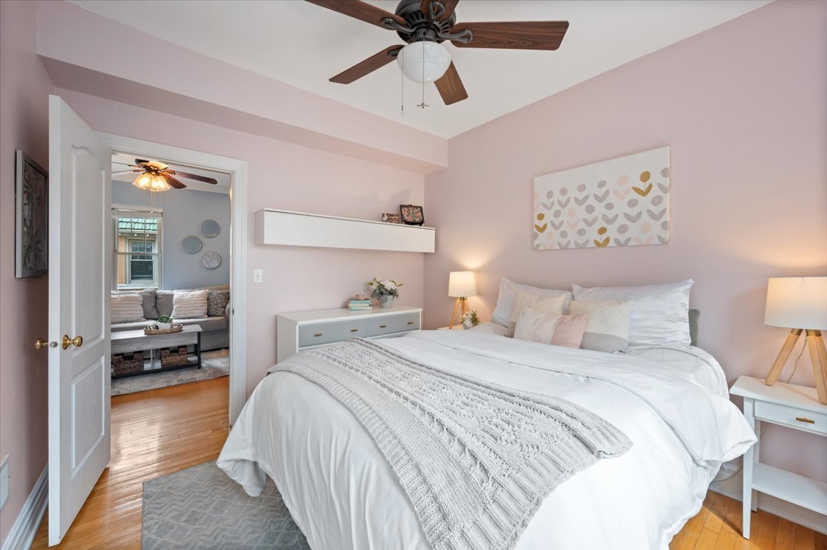 3135 West Palmer Square, Unit 3 Chicago, IL 60647 - Photo 19 of 30 a bedroom with a bed and a chandelier