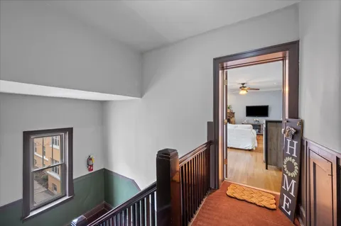 a view of a hallway with windows and stairs