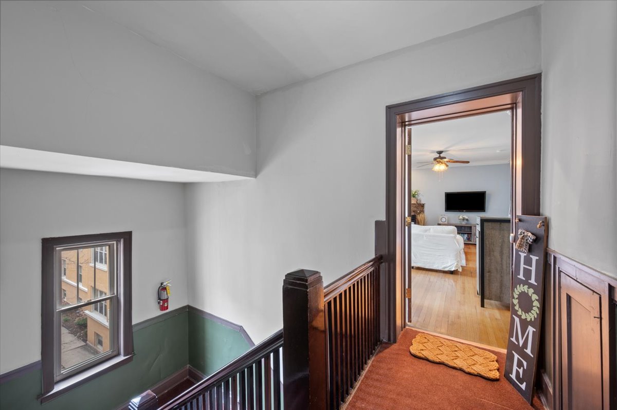 3135 West Palmer Square, Unit 3 Chicago, IL 60647 - Photo 2 of 30 a view of a hallway with windows and stairs
