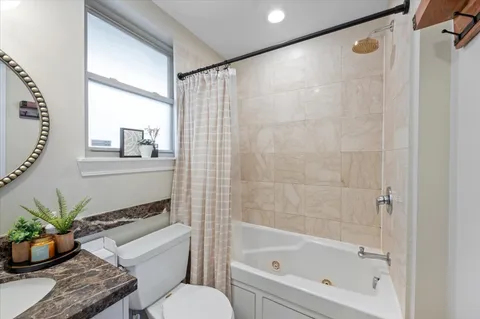 a bathroom with a bathtub and a shower