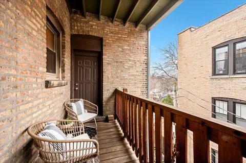 a view of a balcony with furniture