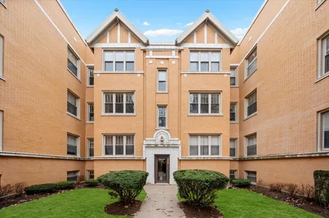 a view of a brick building next to a yard