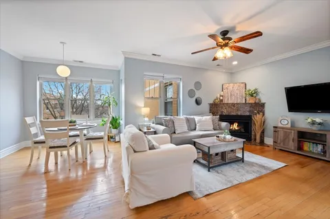 a living room with fireplace furniture and a flat screen tv