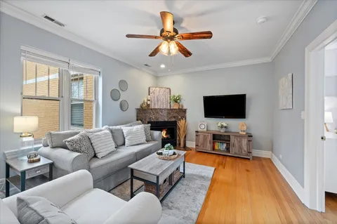 a living room with furniture a flat screen tv and a fireplace