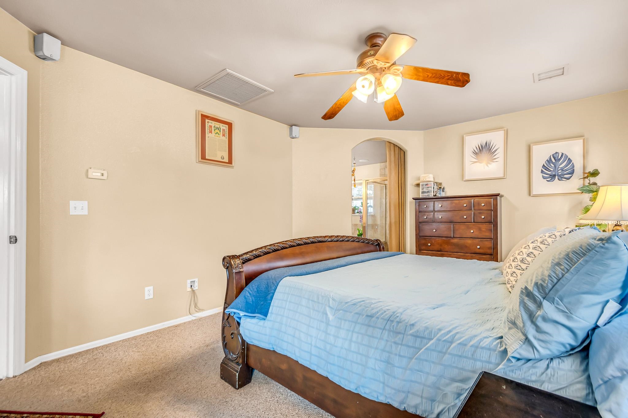 697 Jasper Drive Fruita, CO 81521 - Photo 13 of 26 a bedroom with a bed and wooden floor