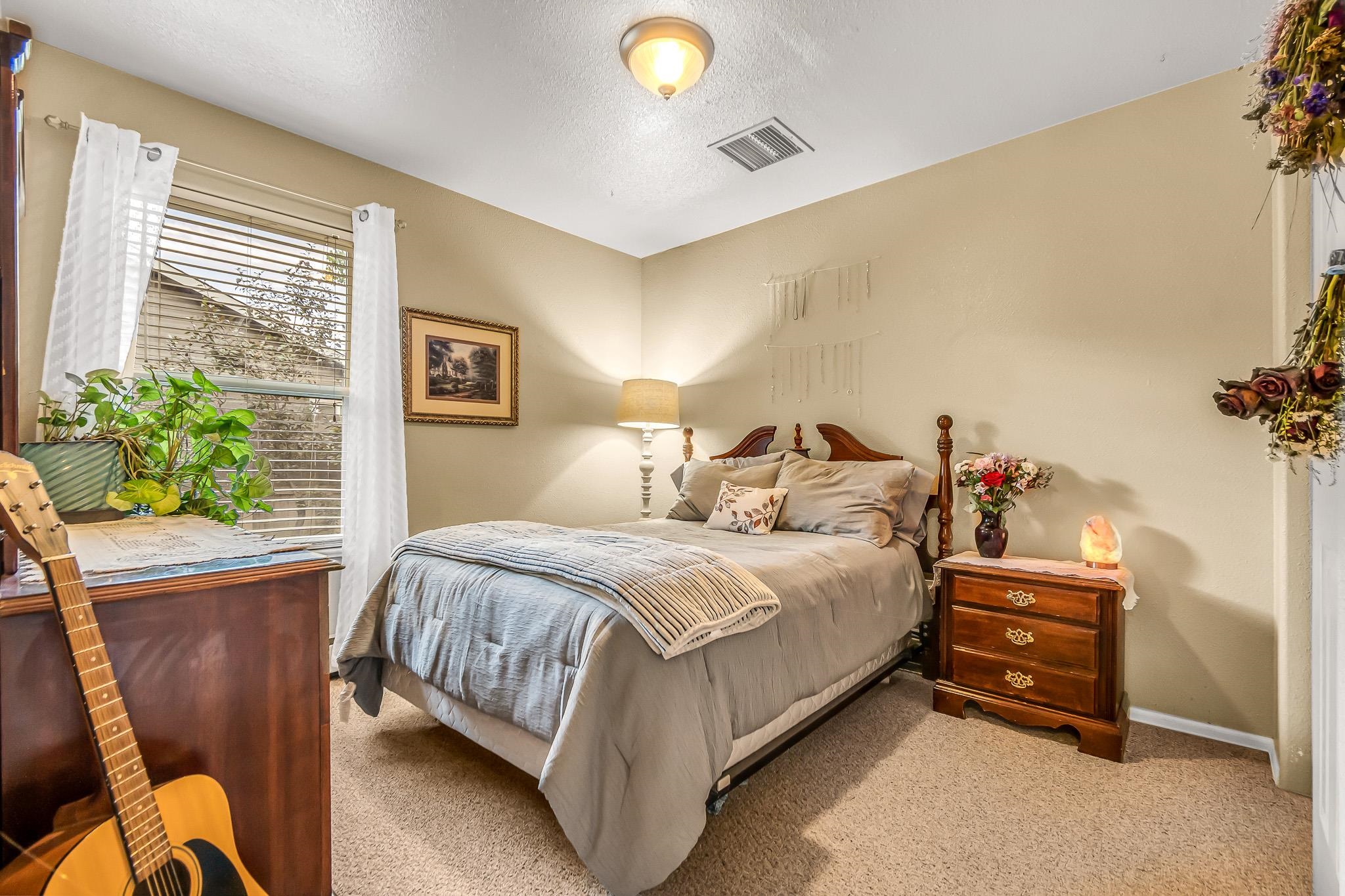 697 Jasper Drive Fruita, CO 81521 - Photo 16 of 26 a bed room with a bed and a chair