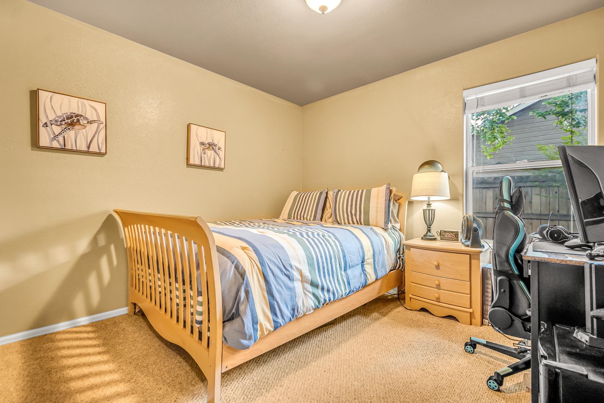 697 Jasper Drive Fruita, CO 81521 - Photo 17 of 26 a bedroom with a bed and a flat screen tv