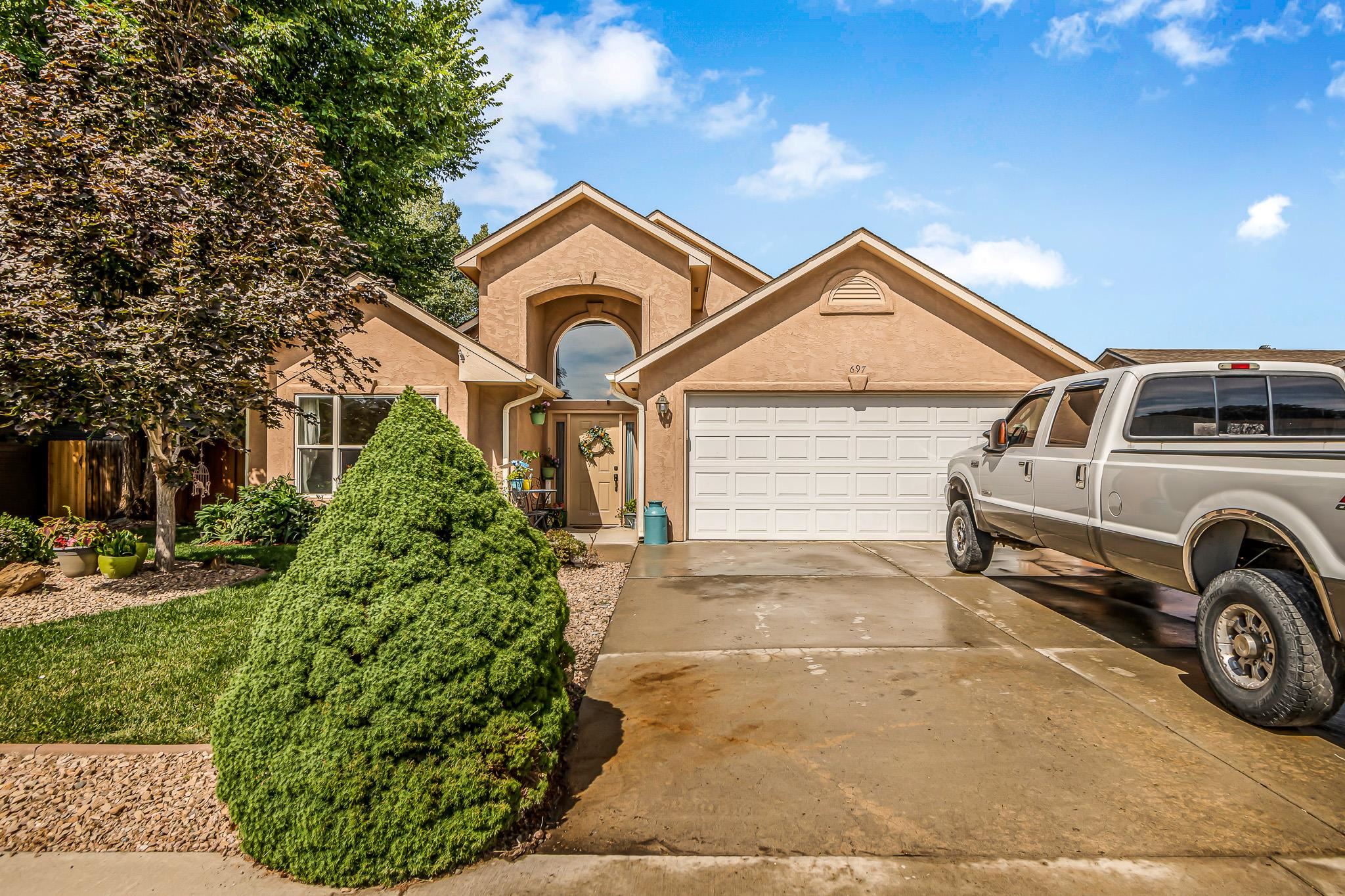 697 Jasper Drive Fruita, CO 81521 - Photo 26 of 26 a view of a car parked in front of a house