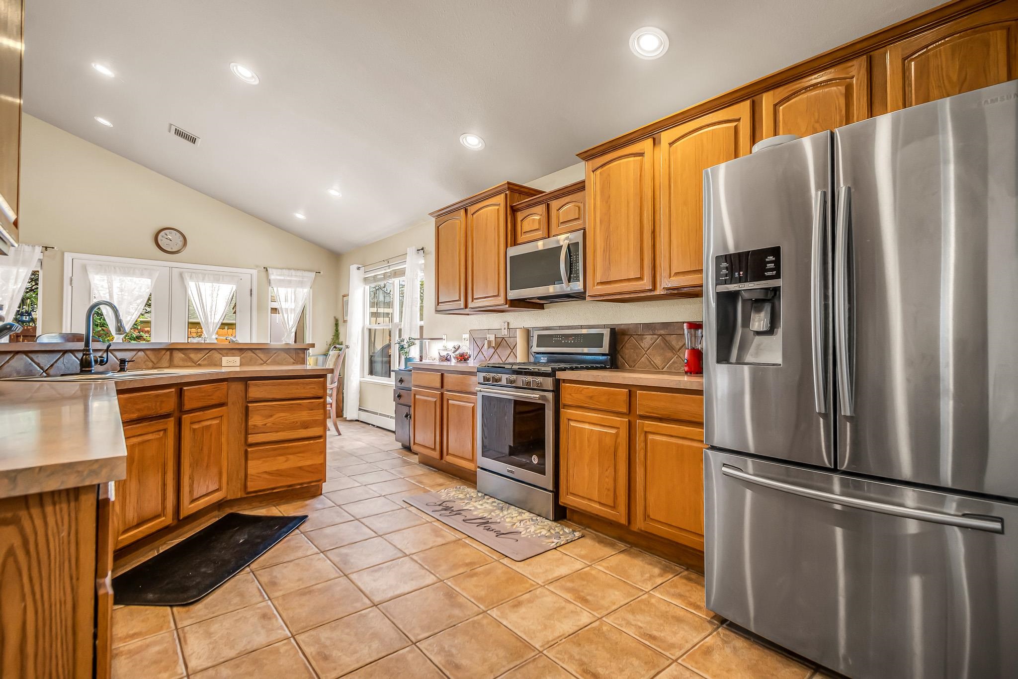 697 Jasper Drive Fruita, CO 81521 - Photo 6 of 26 a kitchen with stainless steel appliances a refrigerator sink and cabinets