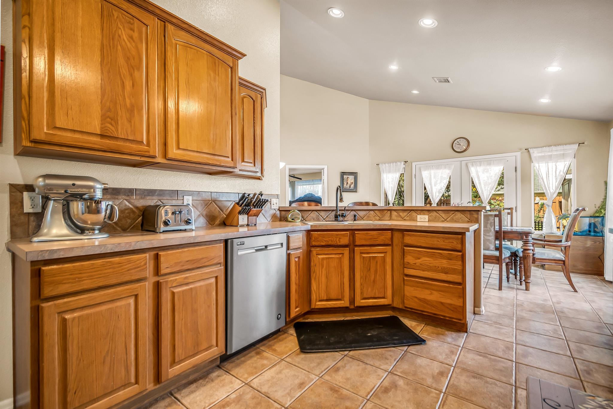 697 Jasper Drive Fruita, CO 81521 - Photo 7 of 26 a kitchen with stainless steel appliances granite countertop a sink and cabinets