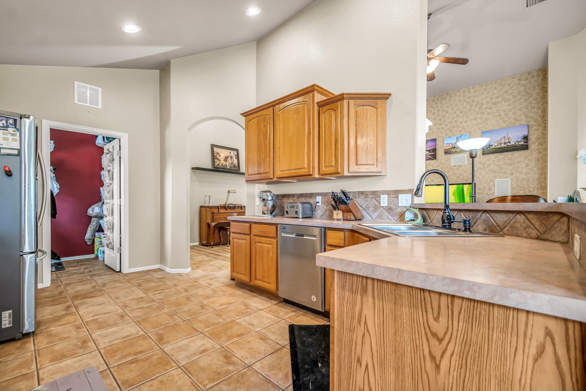 697 Jasper Drive Fruita, CO 81521 - Photo 8 of 26 a kitchen with stainless steel appliances granite countertop a sink a stove and a refrigerator