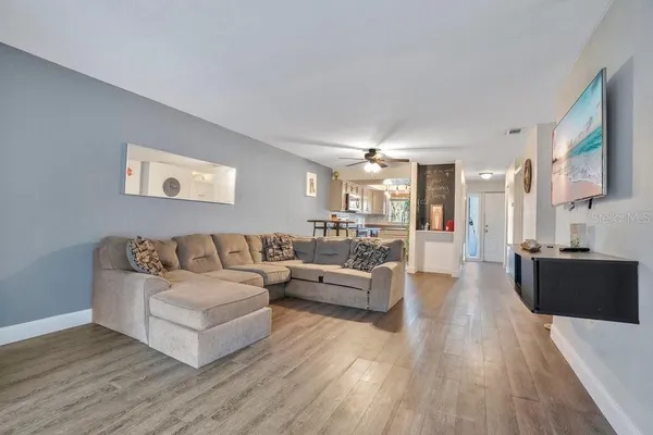 a living room with furniture and a wooden floor