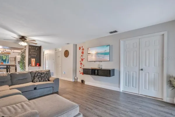 a living room with furniture and a wooden floor