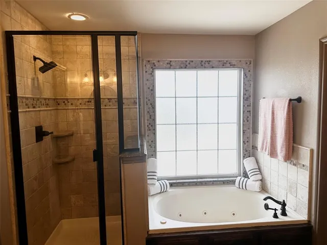a view of bathroom with bathtub and shower