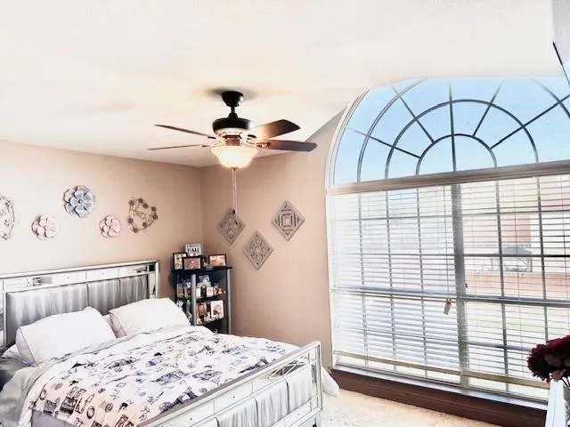 a bedroom with a large bed and a window