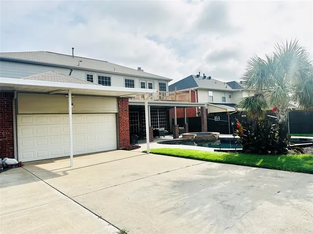 a view of swimming pool with outdoor seating and plants