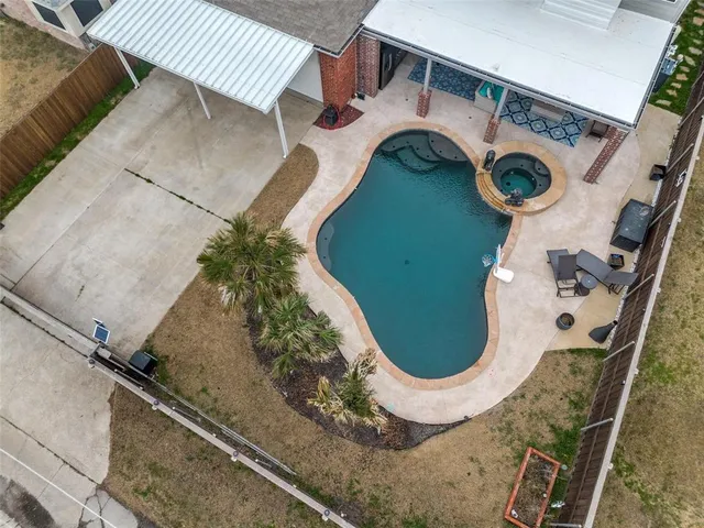 a living room with patio furniture and a floor to ceiling window