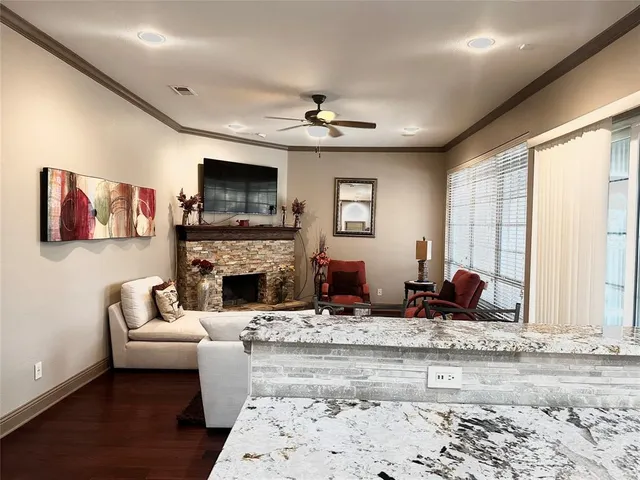 a living room with furniture fireplace and flat screen tv