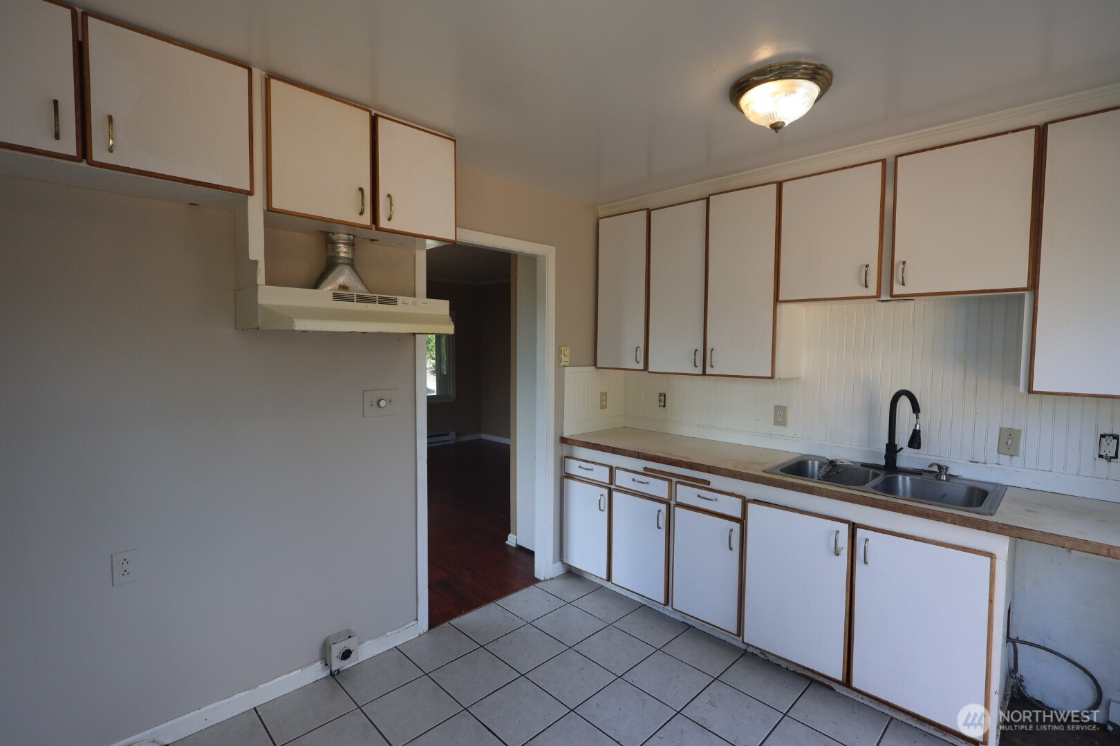 2604 South 122nd Street Seattle, WA 98168 - Photo 13 of 17 a kitchen with stainless steel appliances granite countertop a sink and a refrigerator