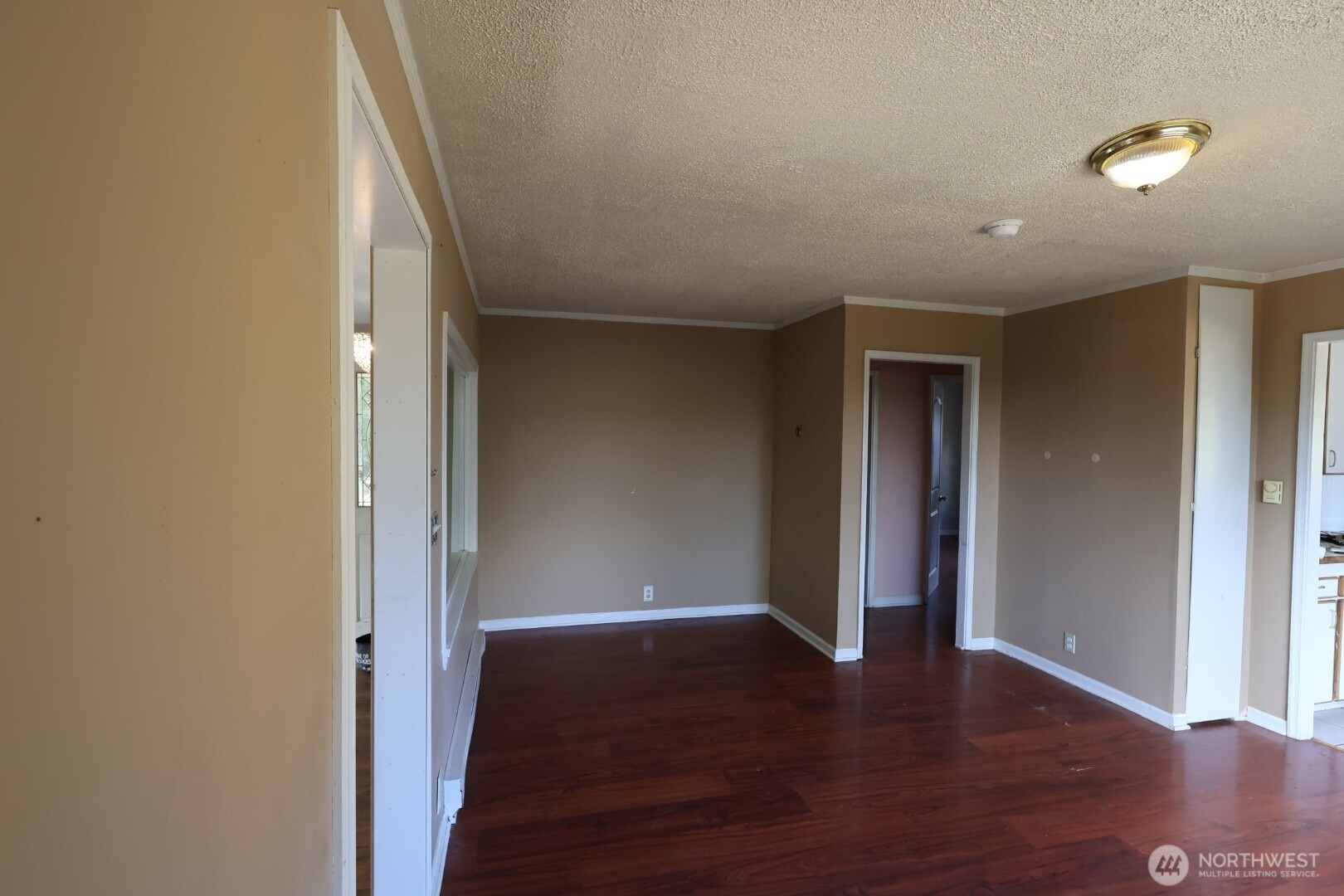 2604 South 122nd Street Seattle, WA 98168 - Photo 5 of 17 a view of an empty room with wooden floor