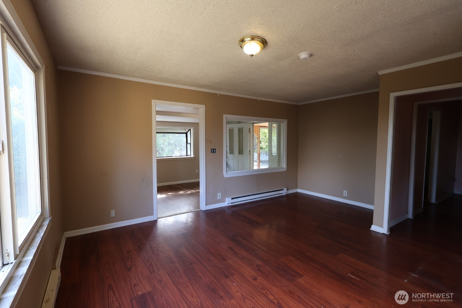 2604 South 122nd Street Seattle, WA 98168 - Photo 6 of 17 an empty room with wooden floor and windows