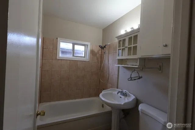 a bathroom with a sink mirror toilet and bathtub