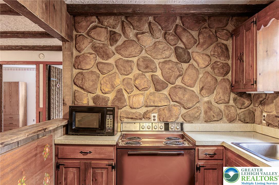 5211 Fir Lane Pocono Summit, PA 18346 - Photo 12 of 38 a kitchen with a stove and a microwave