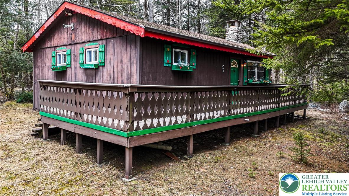 5211 Fir Lane Pocono Summit, PA 18346 - Photo 2 of 38 a view of a deck with a yard