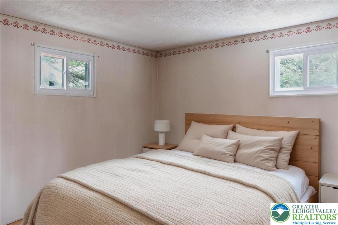 5211 Fir Lane Pocono Summit, PA 18346 - Photo 24 of 38 a bedroom with a bed and a window