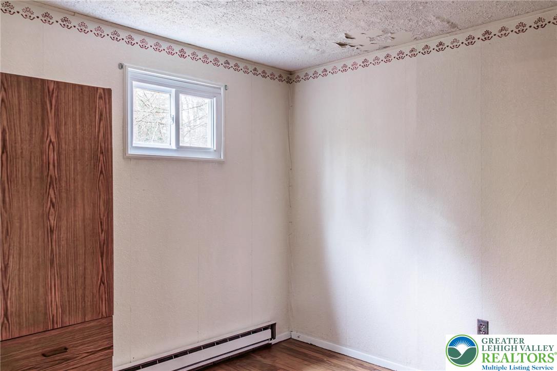 5211 Fir Lane Pocono Summit, PA 18346 - Photo 25 of 38 a view of room with window and hardwood floor