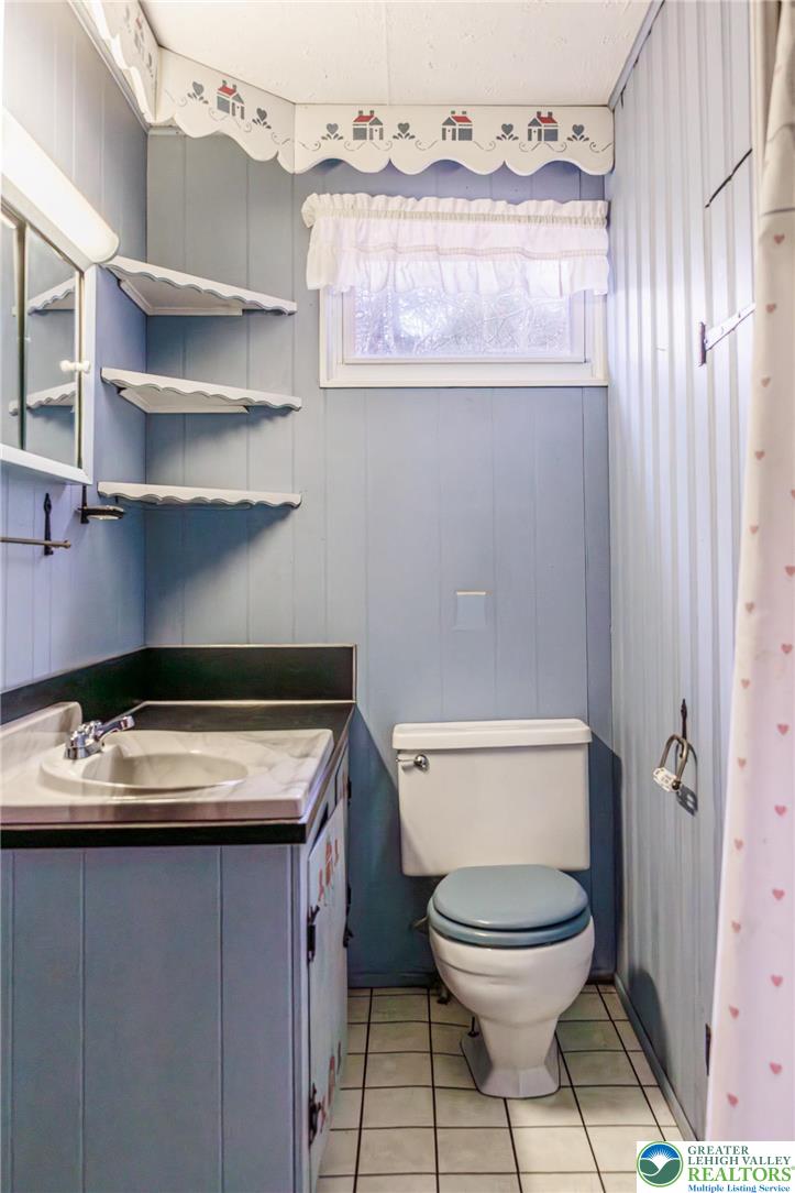 5211 Fir Lane Pocono Summit, PA 18346 - Photo 26 of 38 a bathroom with a granite countertop toilet and a sink