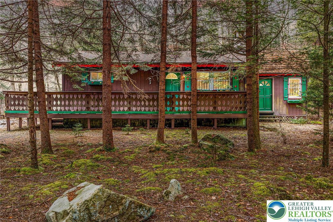 5211 Fir Lane Pocono Summit, PA 18346 - Photo 3 of 38 a view of a house with large trees and sitting area