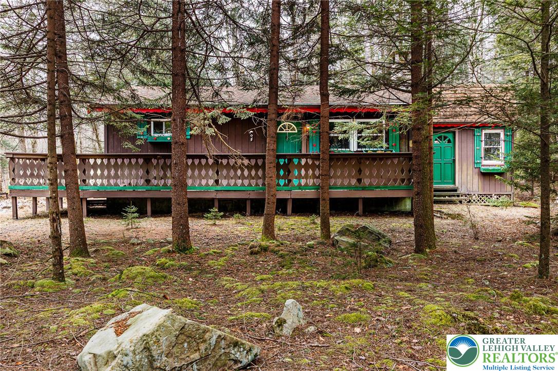 5211 Fir Lane Pocono Summit, PA 18346 - Photo 4 of 38 a view of a house with large trees and sitting area