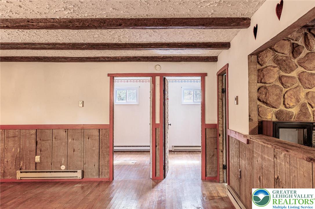 5211 Fir Lane Pocono Summit, PA 18346 - Photo 10 of 38 a view of a hallway with wooden floor and staircase