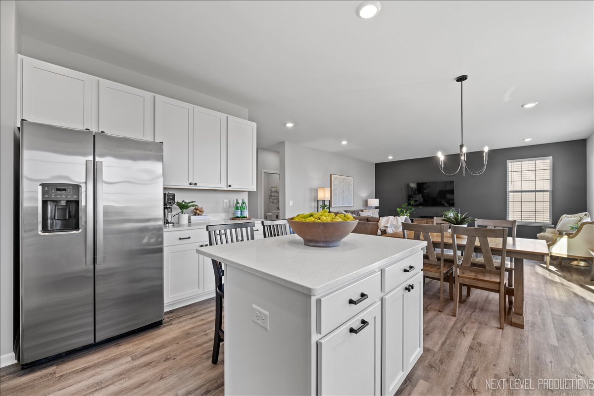 2236 Fairfax Way Yorkville, IL 60560 - Photo 13 of 28 a kitchen with white cabinets and stainless steel appliances